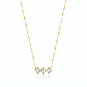 The 14K Gold Trio Necklace is a delicate piece with three small, round diamond stones set in a row on a thin, hypoallergenic gold chain against a light background.