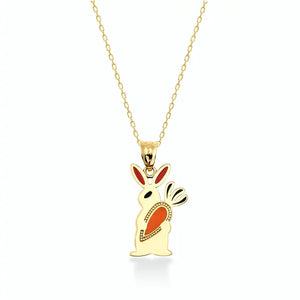 The 14K Gold Cute Rabbit Holding Carrot Necklace by RundaJewelryUs features a delicate rabbit-shaped pendant crafted from 14K gold, with vibrant red and orange enamel accents on its ears and body. Ideal for those who love distinctive jewelry, this piece adds a whimsical touch to any collection.