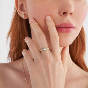 The 14K Solid Gold Natural Pearl Ring from Runda's Elegance Collection features a polished gold band showcasing a single round natural pearl in an elegant, slightly scalloped bezel on top, highlighting Runda's fine handcrafting against a plain white background.