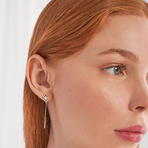 The 14K Solid Gold Emphasis Natural Pearl Dangle Earrings from the Elegance Collection feature genuine pearls set in a hexagonal frame crafted from real solid gold. Each hypoallergenic earring showcases a sleek, modern design with a chain that ends in a rectangular gold bar.