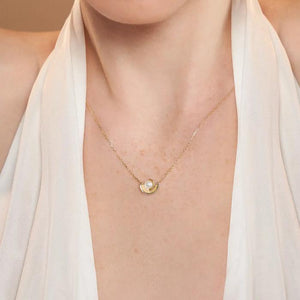 Introducing the Elegance Collection's 14K Solid Gold Natural Pearl Necklace, featuring a circular pendant showcasing a natural pearl at its center. The design includes two gold crescent shapes gently cradling the pearl, all beautifully crafted in 14K real solid yellow gold and suspended on a delicate hypoallergenic gold chain.