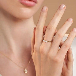 The 14K Solid Gold Bubble Natural Pearl Ring from the Elegance Collection features two rows of small, round beads topped with three larger, natural pearls. Its elegantly modern design showcases Runda's exquisite craftsmanship and is artfully displayed against a plain white background.