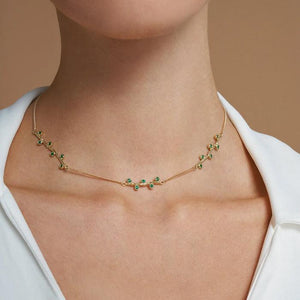 A delicate 14K solid yellow gold piece from the Into the Woods Collection by Erdem Akan, this necklace boasts a fine chain design adorned with small, evenly spaced emerald nano glass-ceramics accents and is elegantly fastened with a simple clasp.