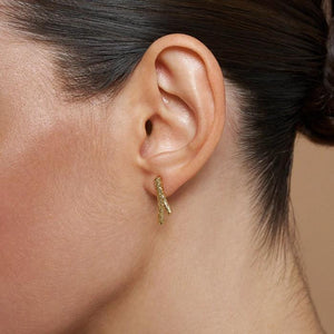 The 14K Solid Gold Tree Branch Stud Earrings from the Into the Woods Collection by Erdem Akan are expertly crafted to resemble small tree branches and are showcased on a white background. Made from authentic 14K solid gold, they feature a textured surface, are hypoallergenic, and designed for pierced ears with visible posts and backings.