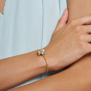 Discover the 14K Solid Gold Acorn Bracelet from the Into the Woods Collection by Erdem Akan, featuring a chain link design with three small conical charms at its center. Each charm is adorned with an abstract design atop a circular gold disc. This hypoallergenic bracelet ensures secure fastening with its lobster claw clasp. Model No B22DK1033.