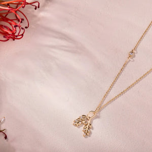 The 14K Solid Gold Olive Branch Pendant Necklace, part of the Chloris Collection, features a delicate chain and a pendant shaped like intertwined branches. Adorned with subtle sparkling lab-grown diamond embellishments and leaves, this hypoallergenic piece is crafted from 14K solid gold, offering elegance and gentleness on the skin.