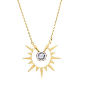 The 14K Solid Gold Sunburst Necklace from the Helios Collection features a sunburst pendant with a central cubic zirconia gemstone, surrounded by elegantly extending spiked rays. It hangs gracefully on a delicate, hypoallergenic chain.