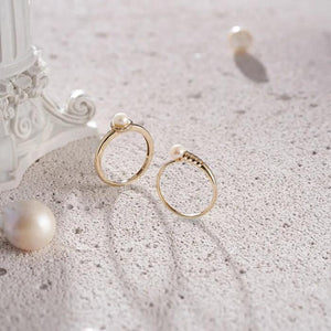 The 14K Solid Gold Natural Pearl Ring from Runda's Elegance Collection features a polished gold band showcasing a single round natural pearl in an elegant, slightly scalloped bezel on top, highlighting Runda's fine handcrafting against a plain white background.