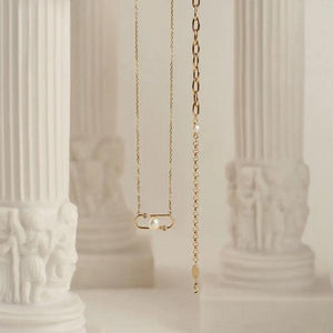 Presenting our 14K Solid Gold Natural Pearl Bracelet from the Elegance Collection, this exquisite piece showcases a blend of round and elongated links in stunning solid gold, decorated with two natural white pearls. Hypoallergenic and crafted with a secure clasp closure, it offers everyday elegance effortlessly.