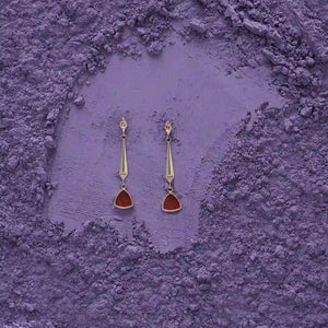 Introducing the 14K Solid Gold Natural Agate/Carnelian Earrings from the Achates Collection. These elegant gold drop earrings showcase elongated tapered stems adorned with triangular carnelian gemstone pendants. Each stem is enhanced with a petite diamond accent near the top, forming a sophisticated and stylish hexagonal design that embodies understated luxury.