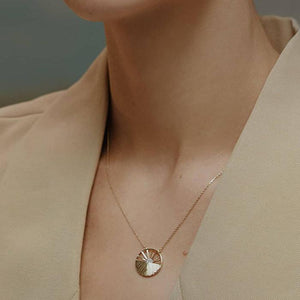 Introducing the 14K Solid Gold Sunrise Necklace from the Helios Collection, this exquisite piece features a pendant shaped like a stylized rising sun. Its radiant rays are artfully crafted with gold lines, while lab-grown diamonds elegantly form the center. The delicate hypoallergenic chain seamlessly complements this stunning pendant.