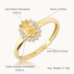 The 14K Solid Gold Citrine November Birthstone Ring features an oval citrine gemstone set in a vintage-style pavé setting with small diamonds arranged in a halo design. The smooth and polished band is crafted from 14K solid gold, marked with "14K" inside, all presented against a plain, light background.