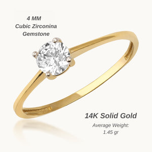 The 14K Solid Gold Zirconia Gemstone Solitaire Ring is artfully crafted with a single round-cut zirconia stone set in a classic prong setting, elegantly showcased against a white background.