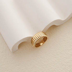 Crafted as part of the Charlotte Line Collection, the 14K Solid Gold Dome Ribbed Ring features a textured and corrugated design with parallel ridges adorning the band. Inside, an intricate lattice pattern enhances the elegance of this beautifully designed ring.