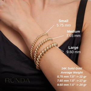 This 14K Real Solid Gold San Marco Bracelet showcases a circular design with a twisted pattern, featuring rounded, shiny links arranged in an elegant spiral. It is displayed against a plain white background.