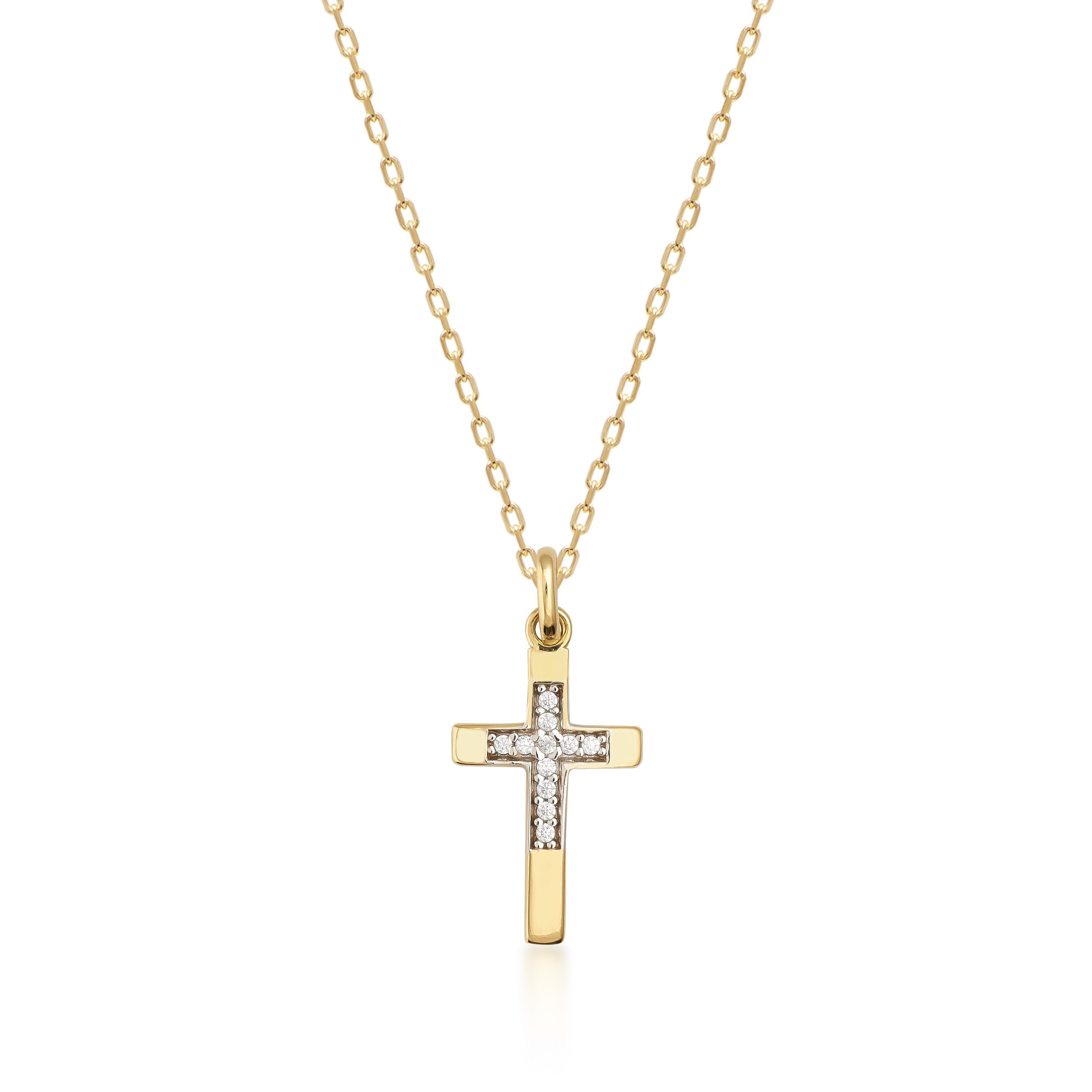 The 14K Solid Gold Tiny Minimal Zirconia Cross Necklace boasts a zirconia cross pendant, embellished with small, sparkling crystals at its center. The pendant dangles from a slender gold chain, imparting an elegant touch to this Christian faith gift. The white background accentuates the necklace's exquisite details.