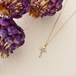 The 14K Solid Gold Tiny Minimal Zirconia Cross Necklace boasts a zirconia cross pendant, embellished with small, sparkling crystals at its center. The pendant dangles from a slender gold chain, imparting an elegant touch to this Christian faith gift. The white background accentuates the necklace's exquisite details.