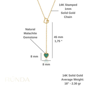 The 14K Solid Gold Heart Lariat Necklace features a sleek and elegant design, with a small heart-shaped malachite pendant at the end. The chain includes an interlocking heart design near the top, enhancing its overall intrigue.