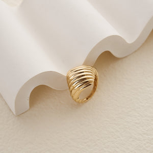 The 14K Solid Gold Chunky Dome Croissant Ring features a bold, ribbed design with multiple smooth, curved bands stacked atop one another for a textured and sculptural appearance. Crafted from solid gold, its polished interior and exterior elegantly catch the light.