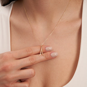 The 14K Solid Gold Minimal Eiffel Tower Pendant Necklace radiates Parisian charm with its elegant design.