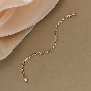 A dainty 14K Real Gold Heart Shaped Link Chain Bracelet showcases interlocking hearts in alternating gold and silver tones, secured with a gold clasp. This elegant design is ideal for those who appreciate delicate jewelry.