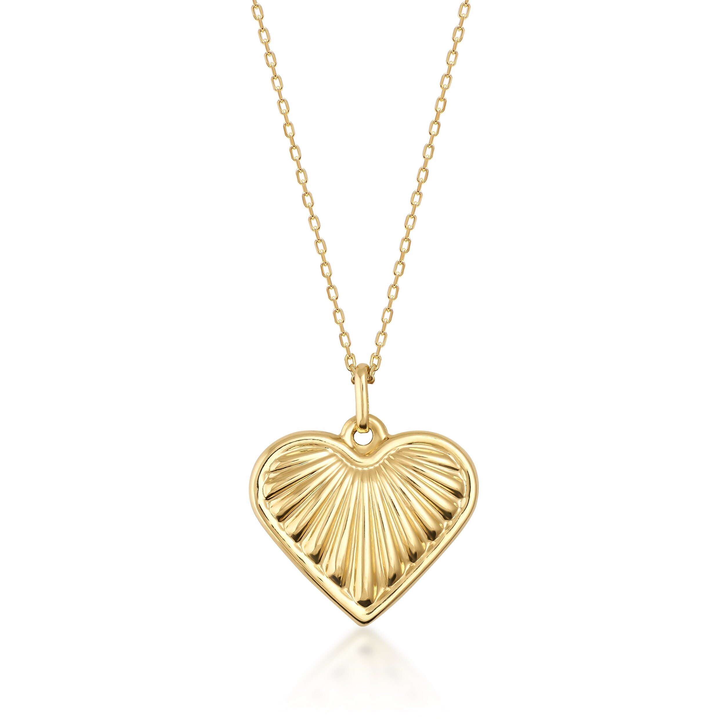 The 14K Gold Necklace features a mariner-inspired heart-shaped pendant with a 3D puffy sea shell design. This elegant pendant is complemented by a delicate gold chain.