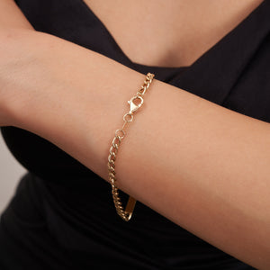 Presenting the 14K Solid Gold Nameplate ID Bracelet, an elegant customizable piece featuring a plain rectangular bar crafted from solid gold. The bracelet is secured with a lobster clasp and showcases a classic Cuban curb chain design with alternating small and larger interlocking links for a timeless style.