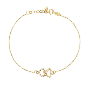 The 14K Solid Gold Minimal Heart and Circle Interlocking Bracelet highlights a delicate design with heart-shaped and circular pendants, the latter adorned with small white stones. This handmade jewelry piece features an adjustable chain and a lobster clasp closure.