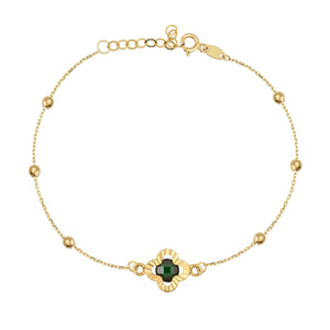 The 14K Solid Gold Emerald Clover Bracelet with Beads is an exquisite piece featuring a floral-shaped green and gold charm at its center. This elegant chain design is adorned with small round gold beads and an adjustable clasp, making it ideal for any occasion.