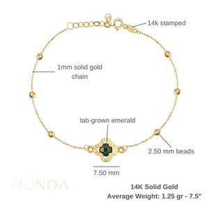 The 14K Solid Gold Emerald Clover Bracelet with Beads is an exquisite piece featuring a floral-shaped green and gold charm at its center. This elegant chain design is adorned with small round gold beads and an adjustable clasp, making it ideal for any occasion.