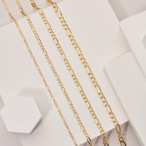 A detailed view of the 14K Solid Gold Figaro Chain for Women & Men, highlighting its interlocking oval and round links. Set against a white background, the hypoallergenic chain exhibits a sleek and polished shine.