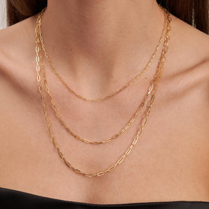 The 14K Solid Gold Paperclip Chain Necklace, featuring elongated oval links and showcased against a white background, epitomizes minimal dainty jewelry.