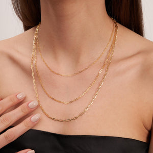 The 14K Solid Gold Paperclip Chain Necklace, featuring elongated oval links and showcased against a white background, epitomizes minimal dainty jewelry.