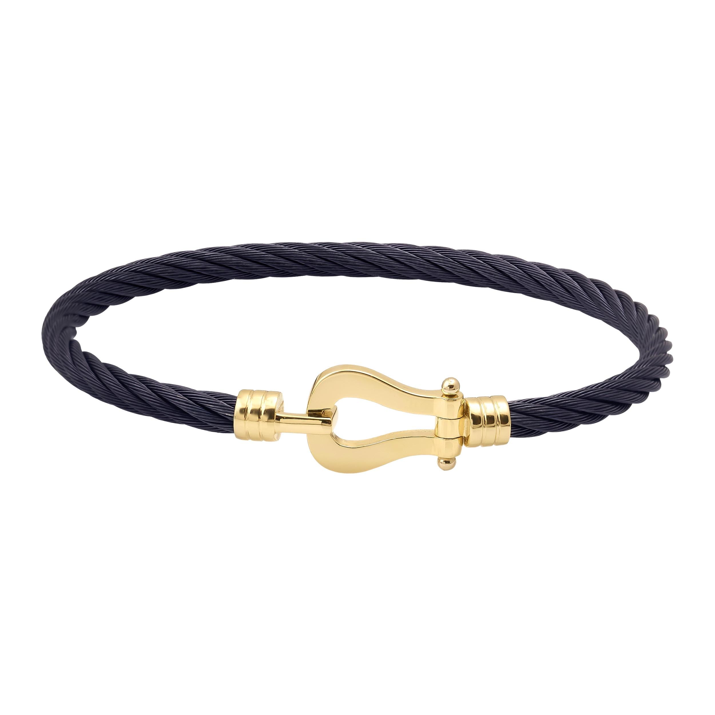 A braided rope bracelet in sleek black featuring a 14K solid gold clasp styled like a shackle. This design marries elegance with simplicity, making it suitable for both casual and formal occasions and an ideal choice for fans of sophisticated handcuff jewelry.