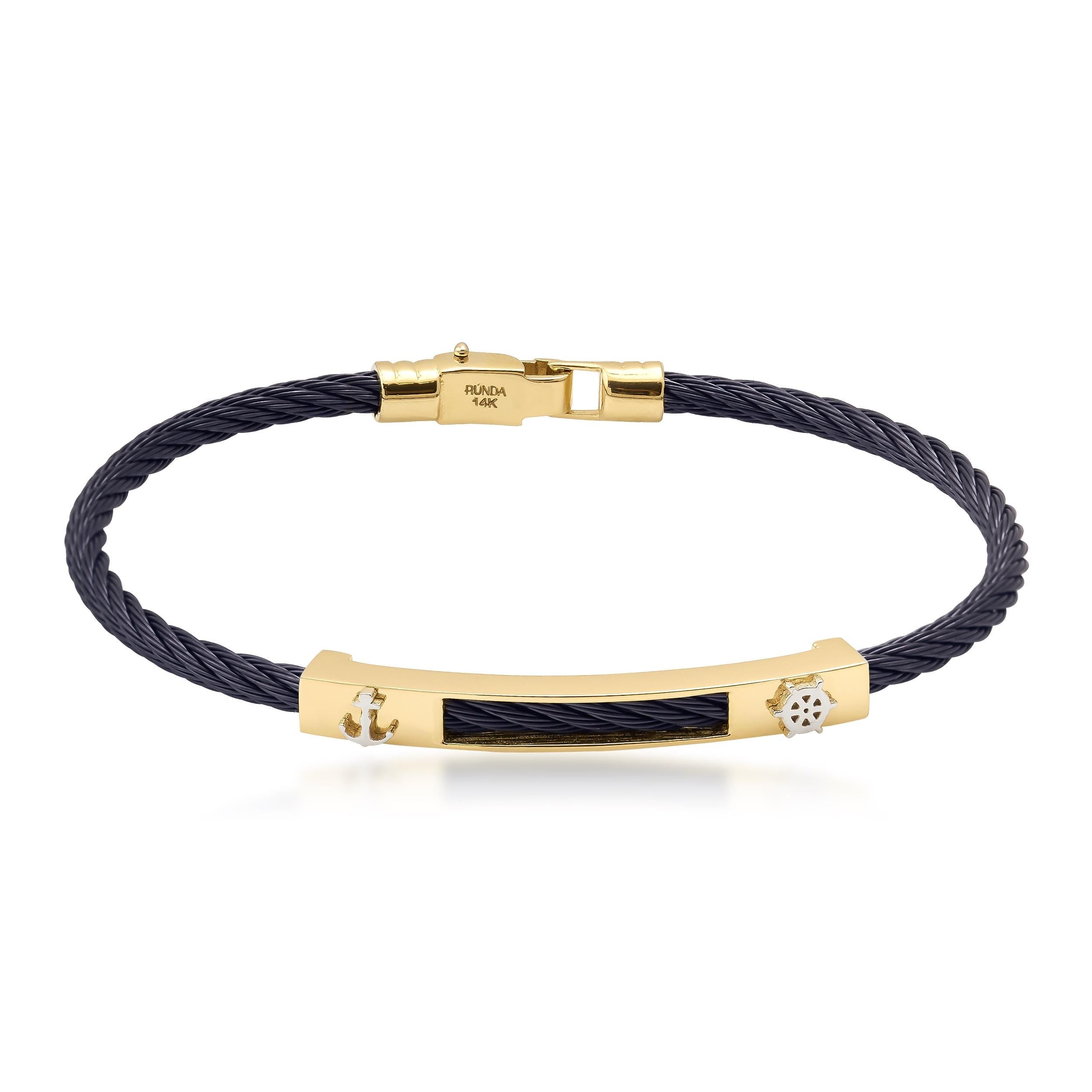 Introducing the 14K Solid Gold Helm & Anchor Bracelet, a chic accessory that showcases a twisted black stainless steel cable band adorned with 14K solid gold accents, featuring a central gold bar and intricate decorative elements.