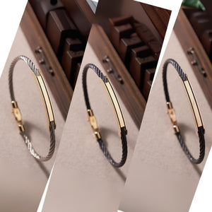 Introducing the 14K Solid Gold Nameplate ID Bracelet for Men, showcasing a sleek design with a twisted black band and a polished gold bar at the center. It features a 14K solid gold nameplate clasp, blending modern elegance that's perfect for those who appreciate fine men's jewelry.