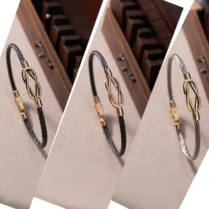 Introducing the 14K Solid Gold Knot Bracelet for Men, featuring a modern and elegant design with a sleek stainless steel bangle. It showcases a black twisted cable band accented by a central gold knot and is secured with a gold clasp.