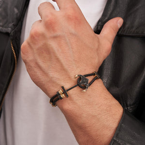 Introducing the 14K Real Solid Gold & Braided Leather Anchor Black Cord Bracelet for Men: A chic bracelet that combines a braided black leather strap with luxurious gold details, including a prominent studded anchor centerpiece. It also features a secure clasp and offers customizable chain sizing for an ideal fit.