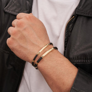 A modern and elegant bracelet designed for men, showcasing square tube nameplate ID with segments of black rubber complemented by shiny engraved gold bars, and secured with a 14K solid gold clasp. Perfect for custom engraving.