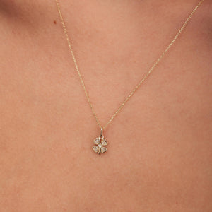 The Diamond Clover Pendant Necklace in 14K Solid Gold for Women gracefully displays a pendant shaped like a four-leaf clover, embellished with natural diamonds, suspended from a delicate chain against a white background.