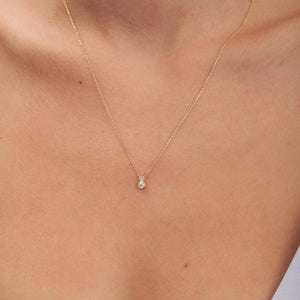 The 14K Solid Gold Diamond Double Bezel Necklace features a pendant with two natural diamonds stacked vertically, finished with a genuine gold chain.