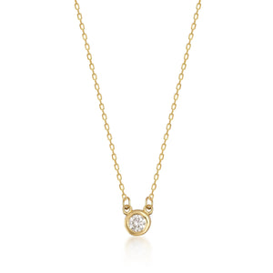 The 14K Solid Gold Diamond Solitaire Bezel Necklace features a delicate chain with a round, bezel-set diamond pendant at the center, showcasing a simple and elegant design that enhances the natural diamond's sparkle.