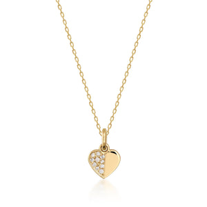 The 14K Solid Gold Tiny Diamond Heart Necklace boasts a heart-shaped pendant that is artistically divided; one side gleams with polished gold, while the other dazzles with an array of small diamonds, creating a stunning sparkle. This exquisite piece exemplifies sustainable handcrafting, featuring a chain that is both delicate and finely crafted.