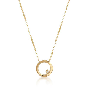 The Real Diamond Minimal Dainty Circle Necklace is crafted from 14K solid gold and features a delicate chain with a circular pendant. Its minimalist design highlights natural diamonds or gemstones that are elegantly embedded near the lower part of the circle.