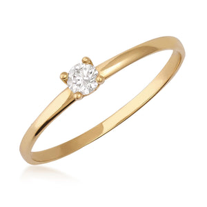 Presenting the 14K Solid Gold Genuine 3 mm Diamond Solitaire Ring, an exquisite engagement piece featuring a single 0.11 Ct. natural diamond set gracefully in a prong setting. The band is slender and refined, enhancing the brilliance of the gemstone against its plain white backdrop, which highlights the simplicity and beauty of this authentic gold ring.