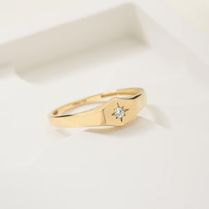 The Natural Diamond Star Setting 14K Solid Gold Ring showcases a sleek, angular design with a single round natural diamond elegantly placed in a star-shaped mounting at its center.