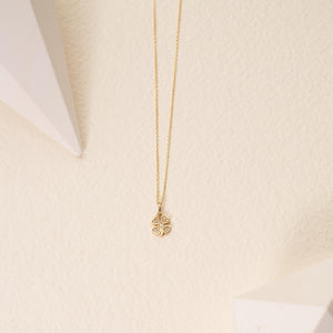 The Diamond Clover Pendant Necklace in 14K Solid Gold for Women gracefully displays a pendant shaped like a four-leaf clover, embellished with natural diamonds, suspended from a delicate chain against a white background.