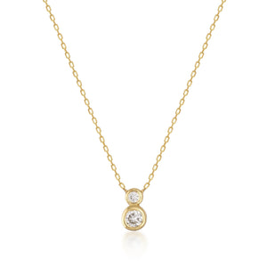 The 14K Solid Gold Diamond Double Bezel Necklace features a pendant with two natural diamonds stacked vertically, finished with a genuine gold chain.