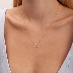 The Diamond Crescent Moon Pendant Necklace in 14K Solid Gold is a refined piece crafted from authentic gold. It showcases a crescent moon pendant embellished with tiny natural diamonds. The slender, graceful chain beautifully accentuates the moon's design, providing an essence of sustainable jewelry luxury.