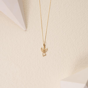 Introducing the 14K Solid Gold Diamond Angel Pendant Necklace, featuring a meticulously crafted angel design from genuine 14K gold. The pendant showcases a heart shape at its center and is elegantly embellished with small diamonds on the robe, while the delicate chain perfectly complements the intricate details of this stunning piece.